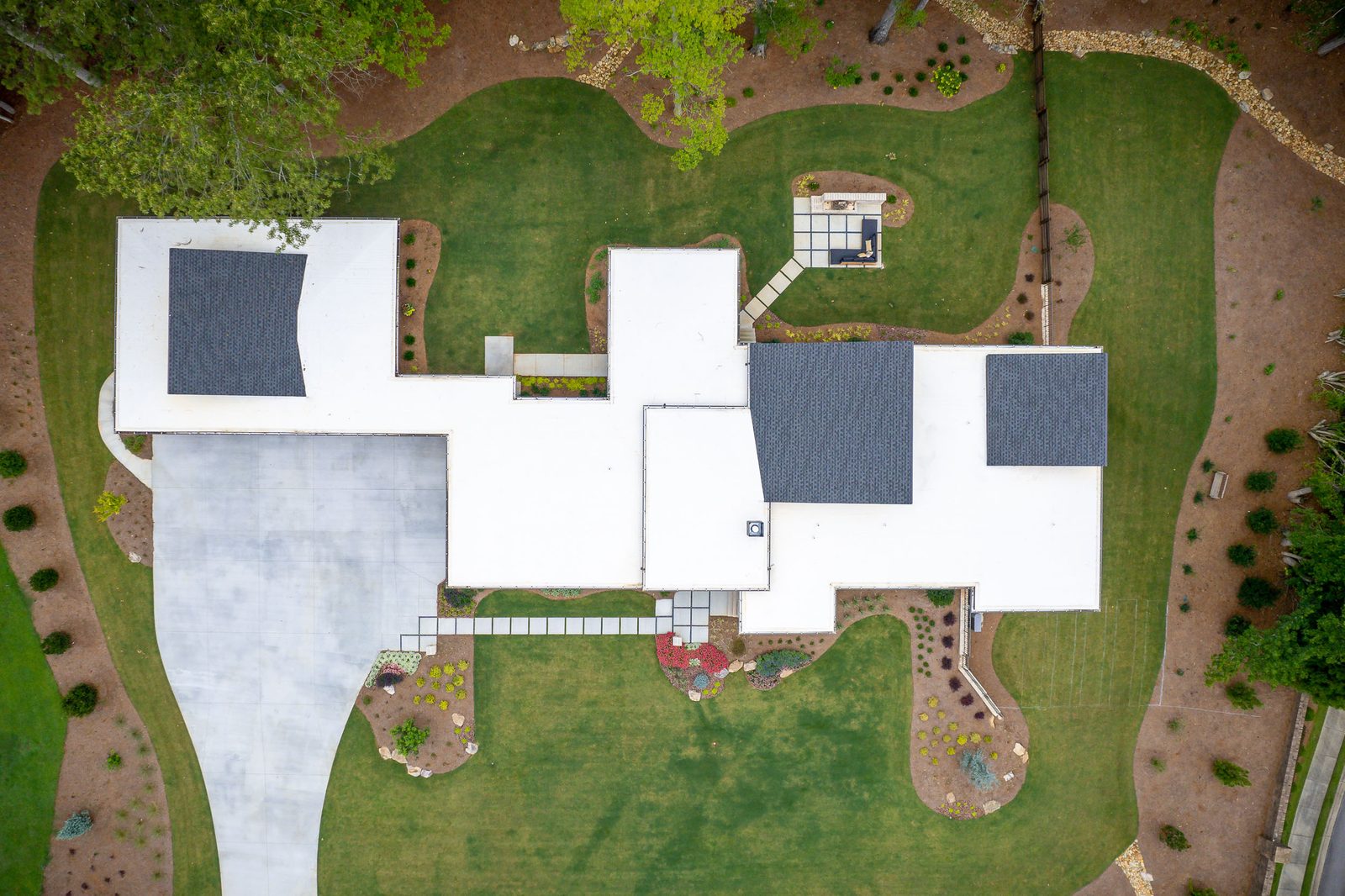 Aerial view over the house and rear yard — The Ortiz Home, custom home built by Ironwood Construction Group in Sugar Hill, Georgia