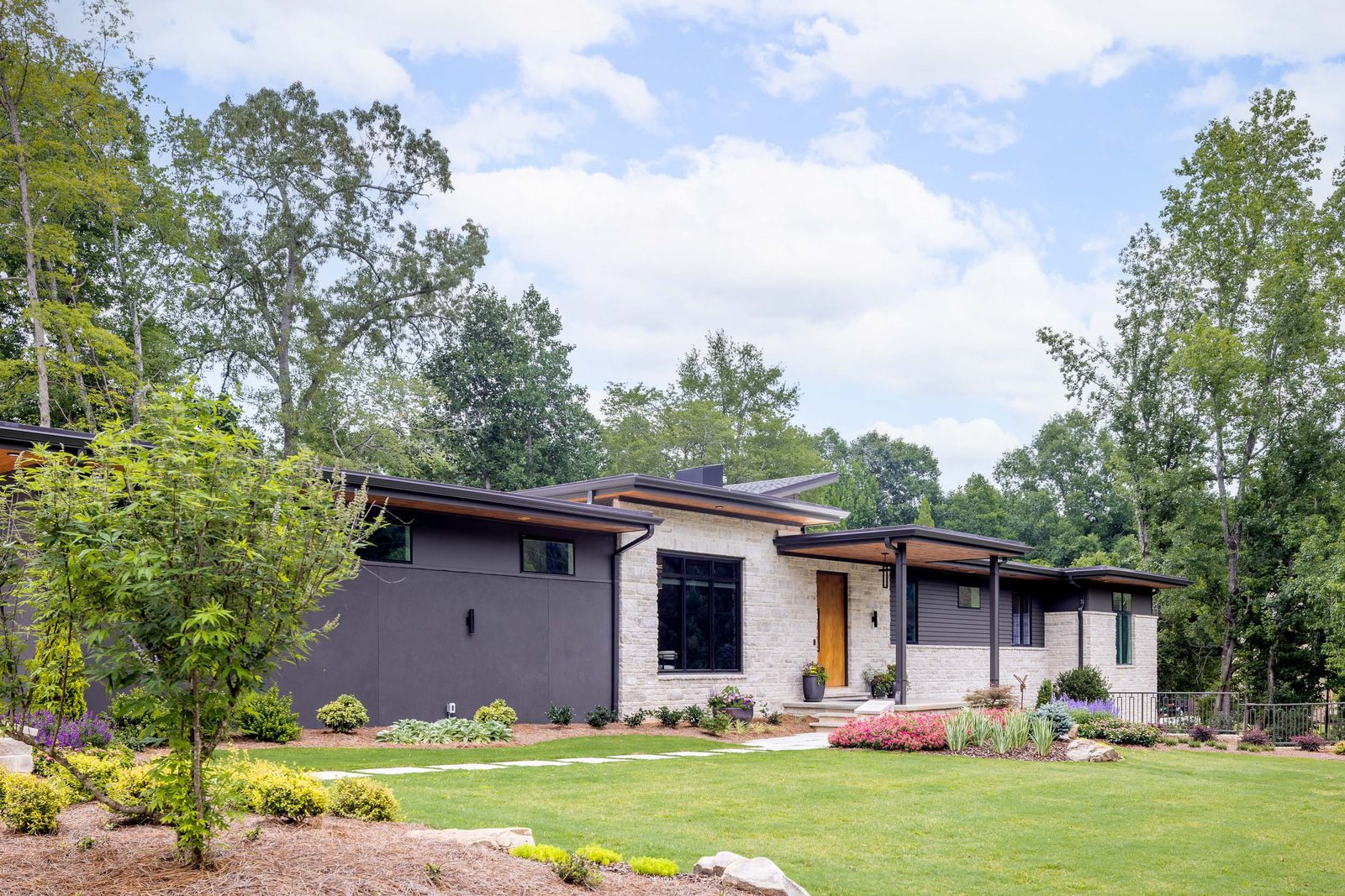 Front elevation of the house seen from the lawn — The Ortiz Home, custom home built by Ironwood Construction Group in Sugar Hill, Georgia