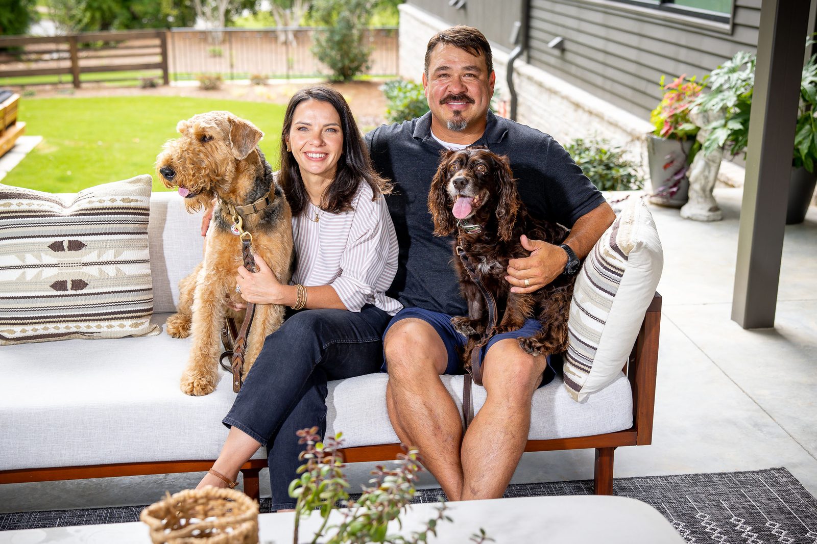 Family portrait with the dogs on the patio — The Ortiz Home, custom home built by Ironwood Construction Group in Sugar Hill, Georgia