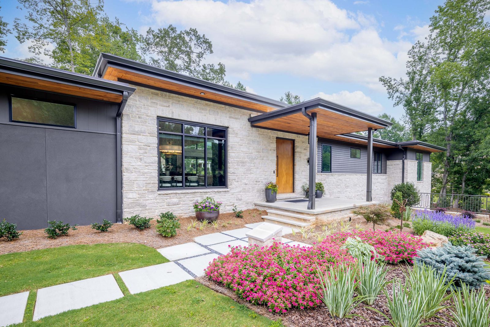 Front elevation with paver walk and pink azaleas — The Ortiz Home, custom home built by Ironwood Construction Group in Sugar Hill, Georgia