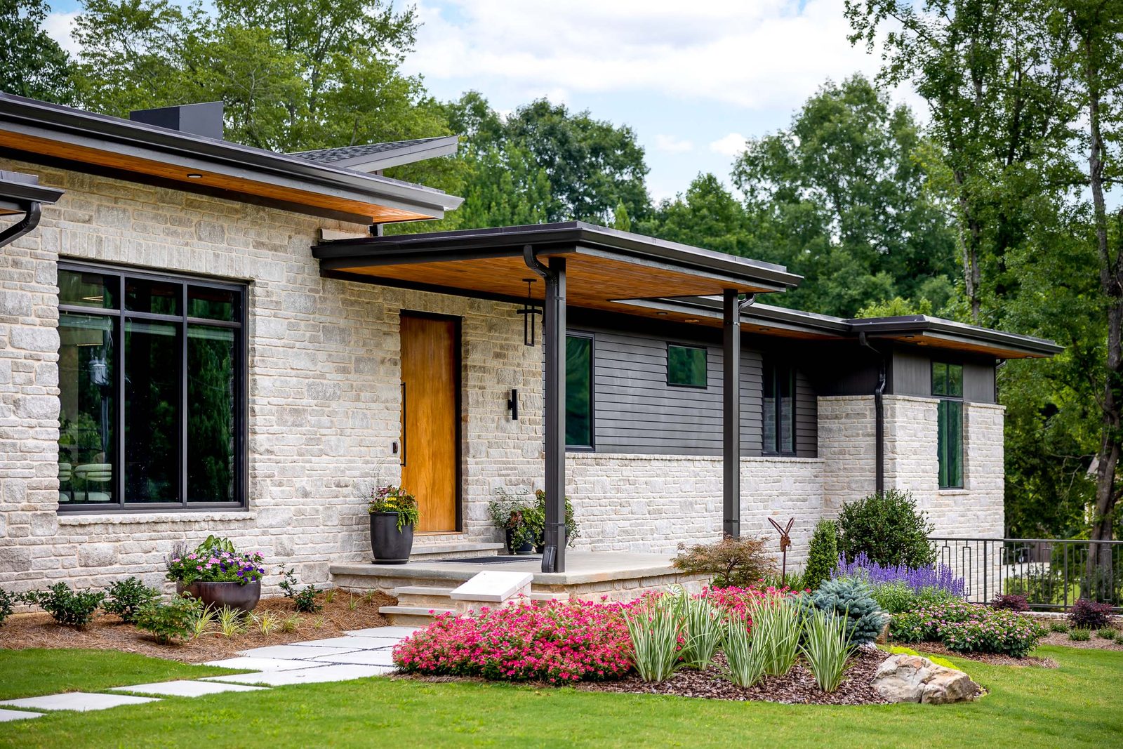 Front elevation with plantings along the walkway — The Ortiz Home, custom home built by Ironwood Construction Group in Sugar Hill, Georgia