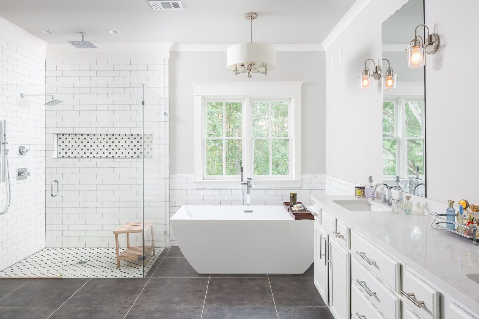 Primary bath with freestanding tub, walk-in shower and double vanity — Austin Garner Rd, custom home built by Ironwood Construction Group