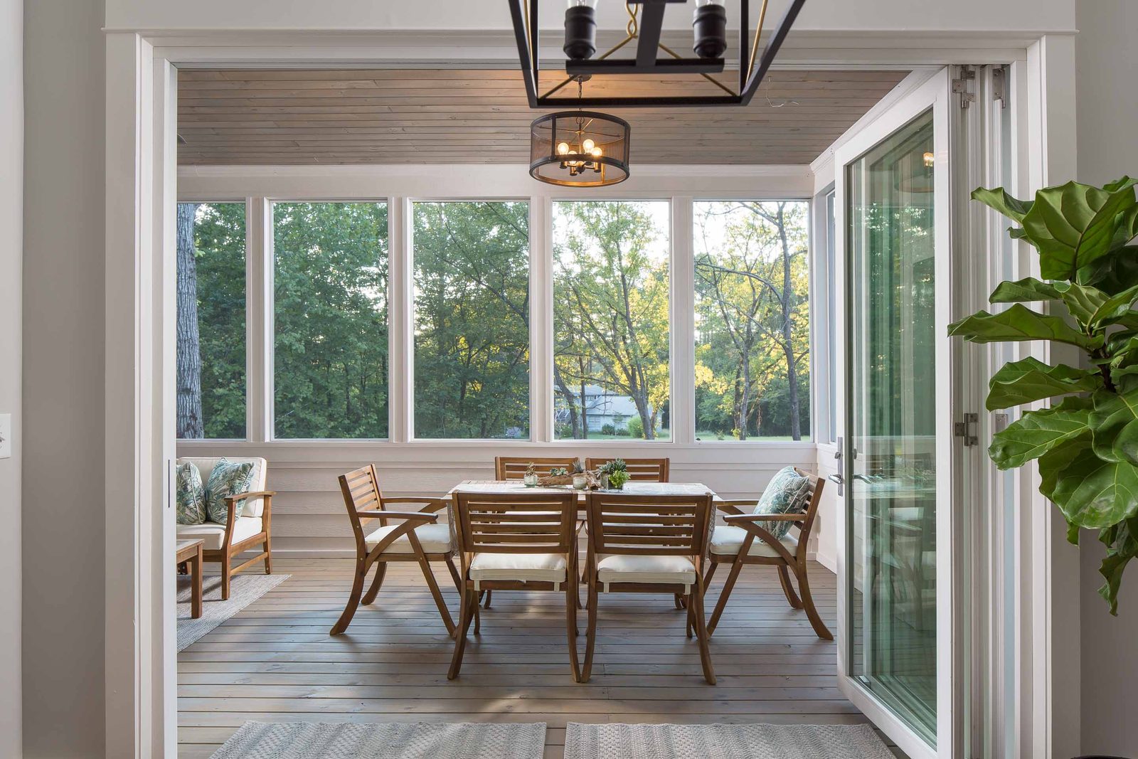 Screened porch with dining table and wood ceiling — Austin Garner Rd, custom home built by Ironwood Construction Group