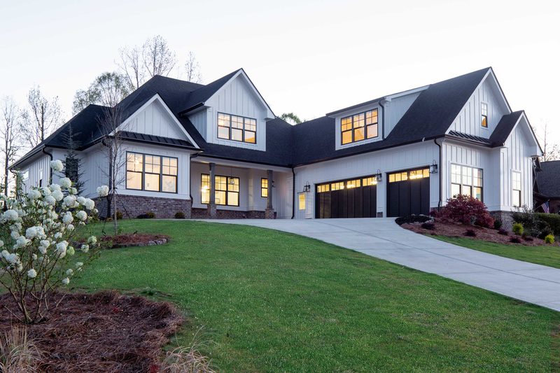 Front elevation of the white board-and-batten farmhouse — Glausier, a custom home built by Ironwood Construction Group