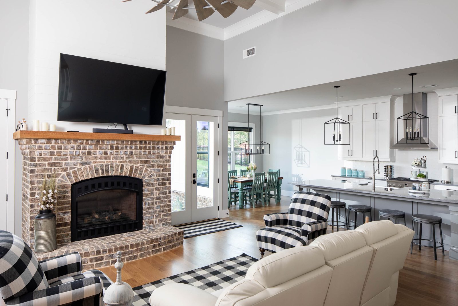 Great room with brick fireplace open to the kitchen — Glausier, custom home built by Ironwood Construction Group