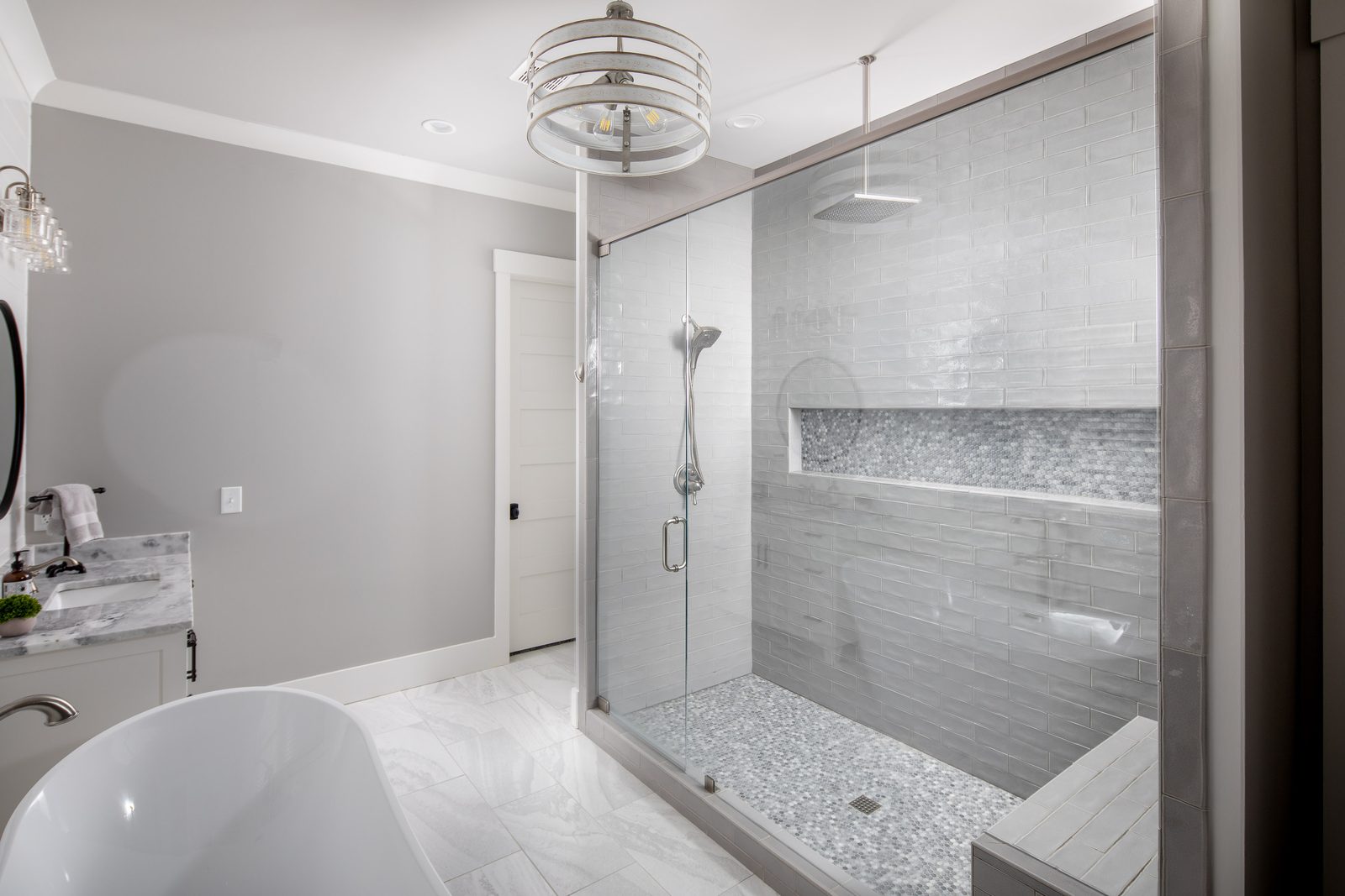 Primary bath walk-in shower with tiled bench — Glausier, custom home built by Ironwood Construction Group