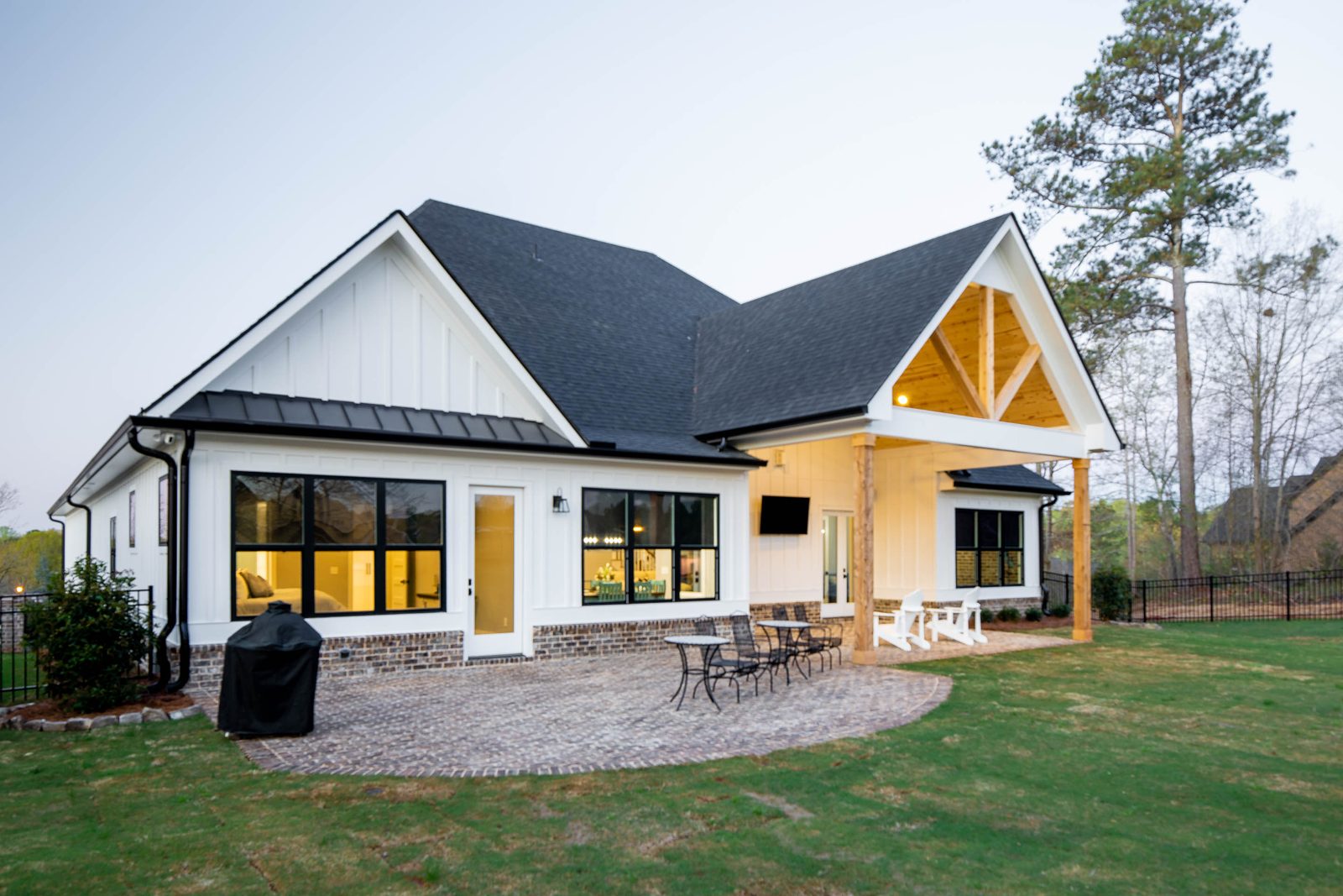 Rear elevation with timber gable and paver patio — Glausier, custom home built by Ironwood Construction Group