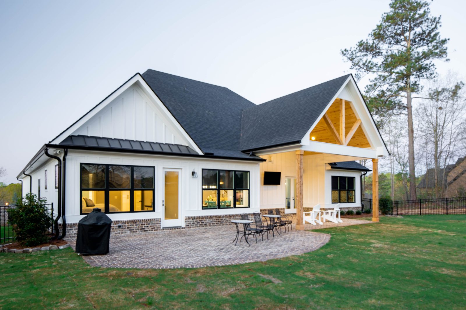 Rear elevation with covered porch and paver fire-pit patio — Glausier, custom home built by Ironwood Construction Group