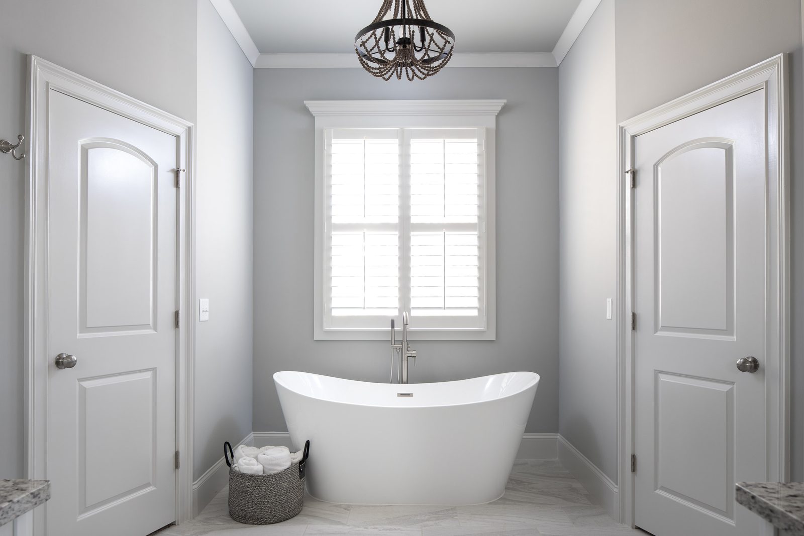 Primary bath with freestanding tub between the closet doors — Imbriale, custom home built by Ironwood Construction Group