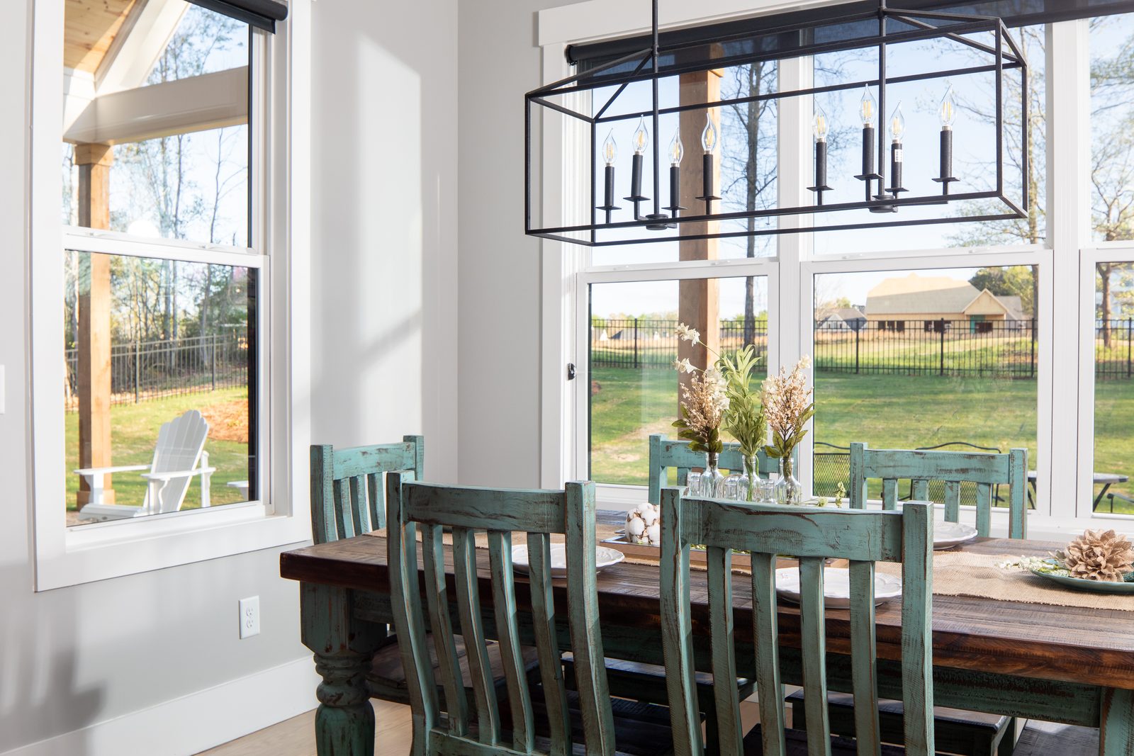Breakfast area with green chairs and lantern lighting — Spring 2020 Custom Home, custom home built by Ironwood Construction Group