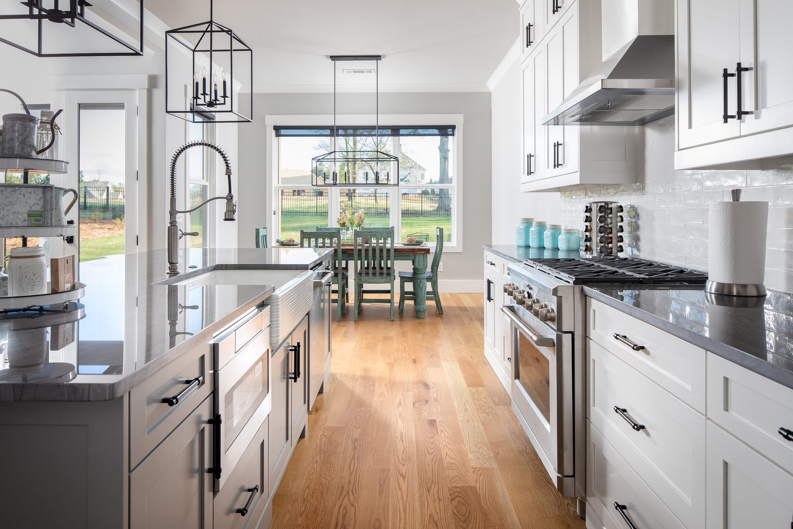Kitchen with brass faucet and range, open to the breakfast area — Spring 2020 Custom Home, custom home built by Ironwood Construction Group