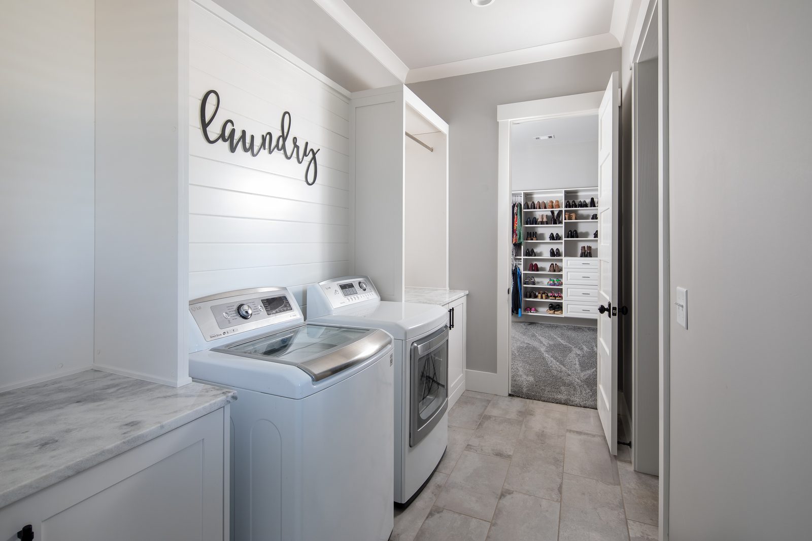 Laundry room with washer, dryer and shiplap wall — Spring 2020 Custom Home, custom home built by Ironwood Construction Group