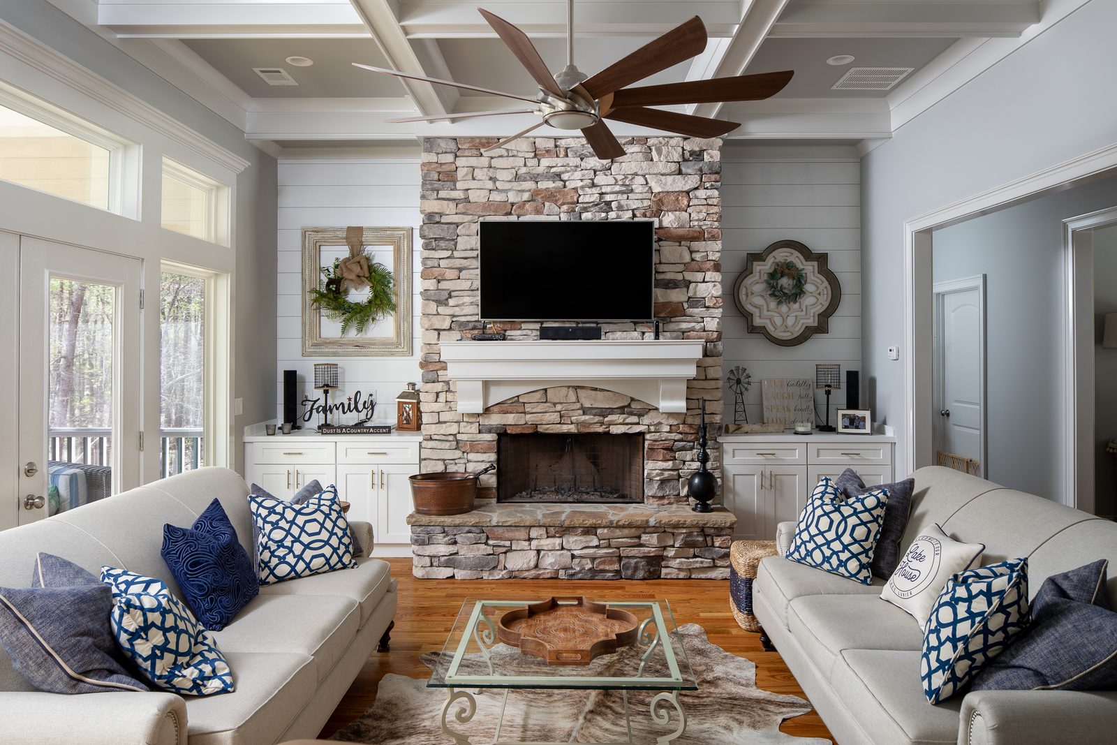 Great room with stone fireplace and sectional seating — Spring 2020 Custom Home, custom home built by Ironwood Construction Group