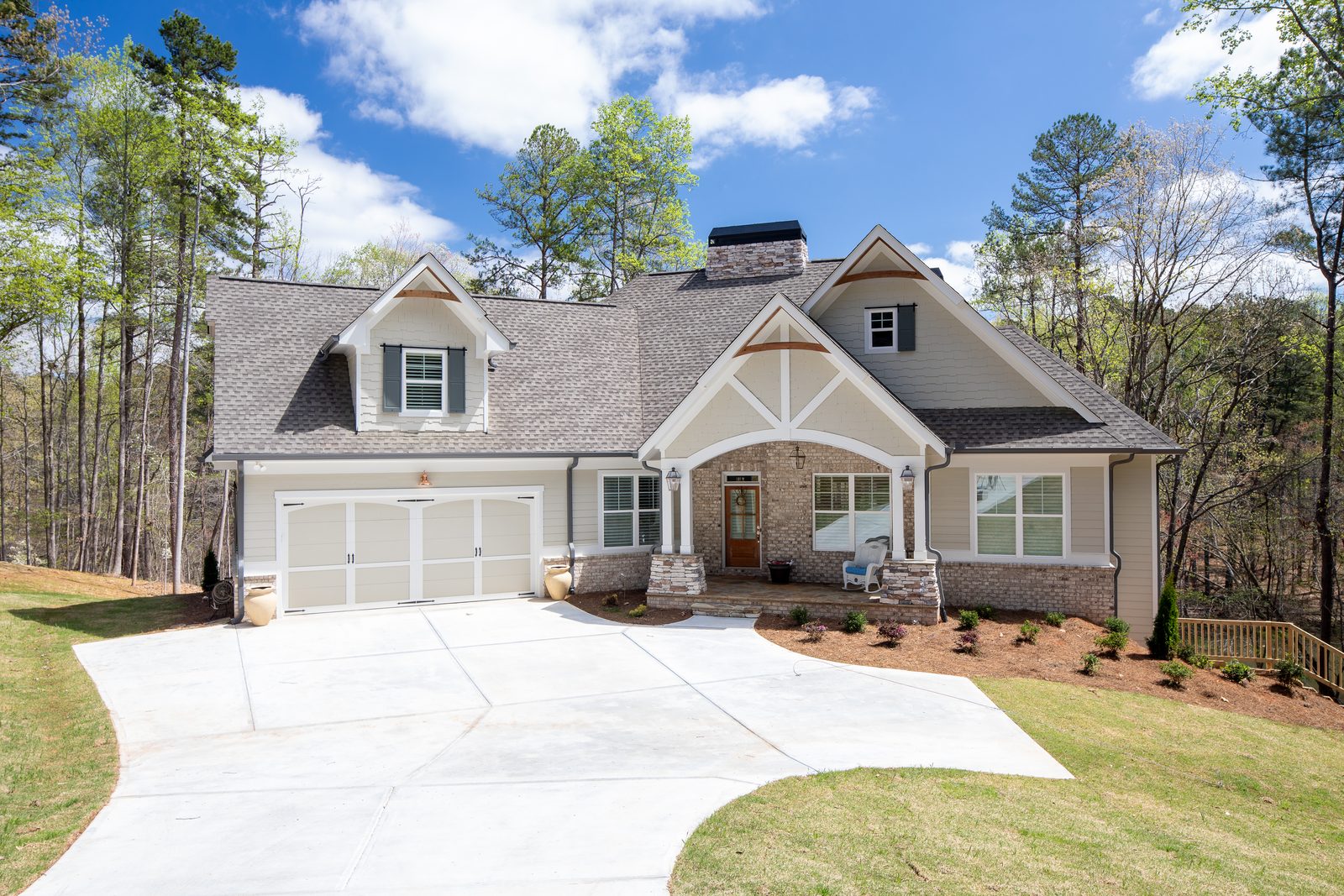 Craftsman front elevation with driveway and stone columns — Spring 2020 Custom Home, custom home built by Ironwood Construction Group