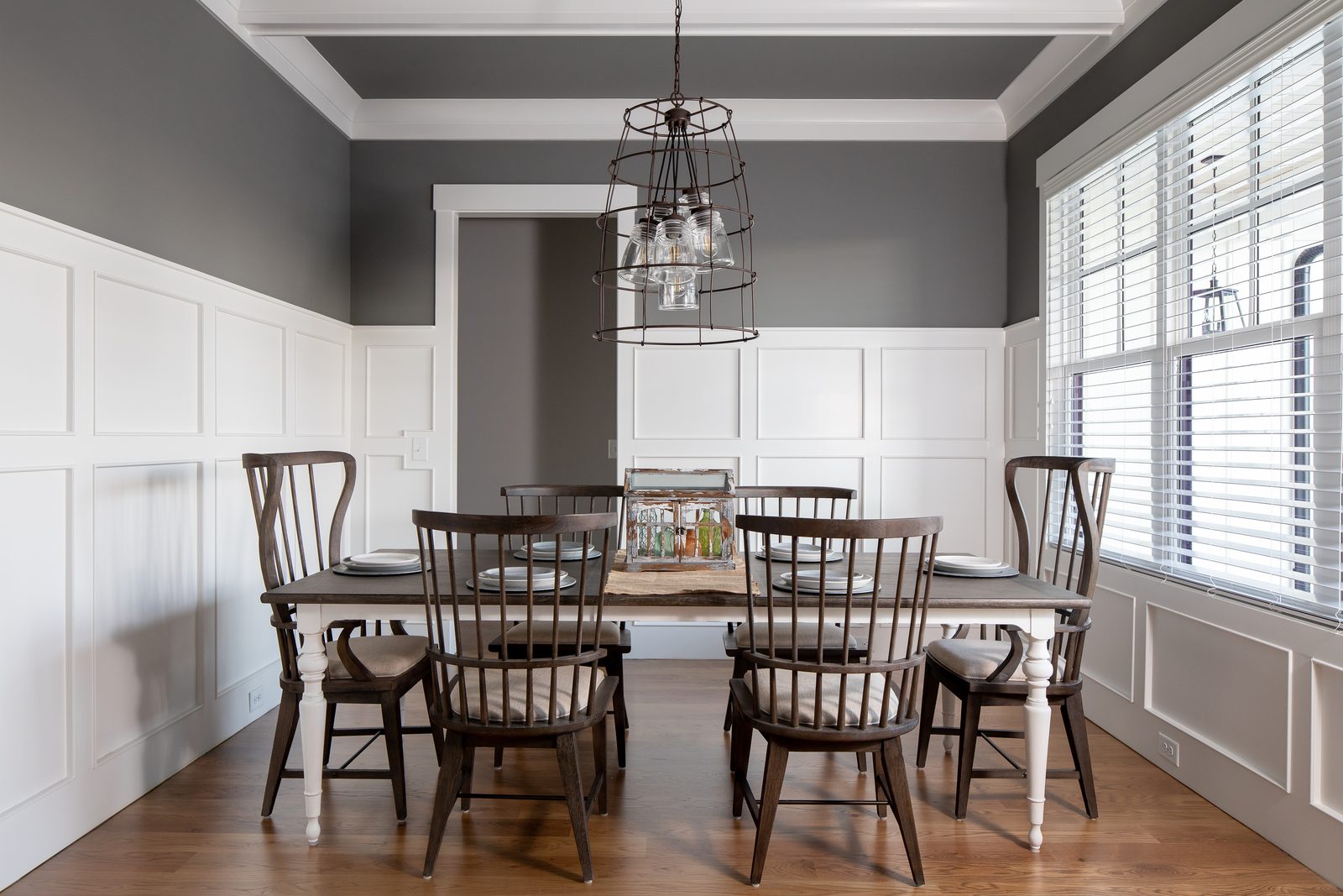 Dining room with spindle chairs and plantation shutters — Spring 2020 Custom Home, custom home built by Ironwood Construction Group