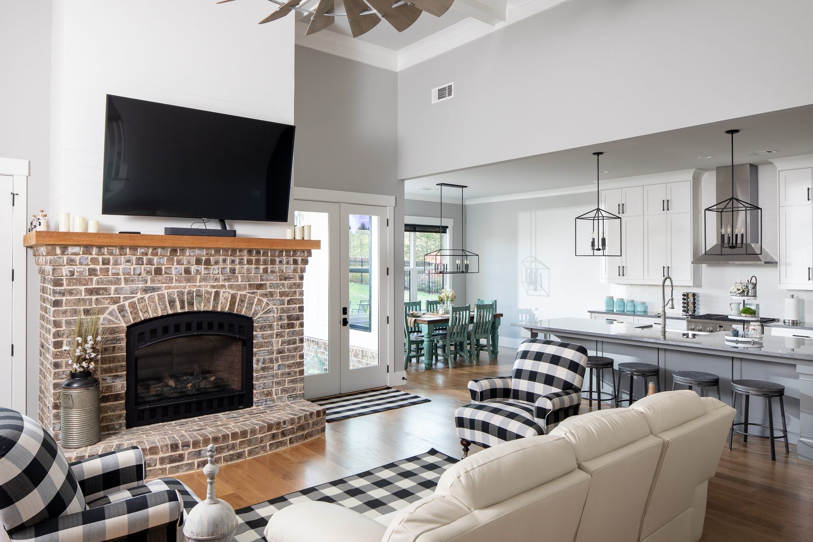 Great room with brick fireplace open to the kitchen — Spring 2020 Custom Home, custom home built by Ironwood Construction Group