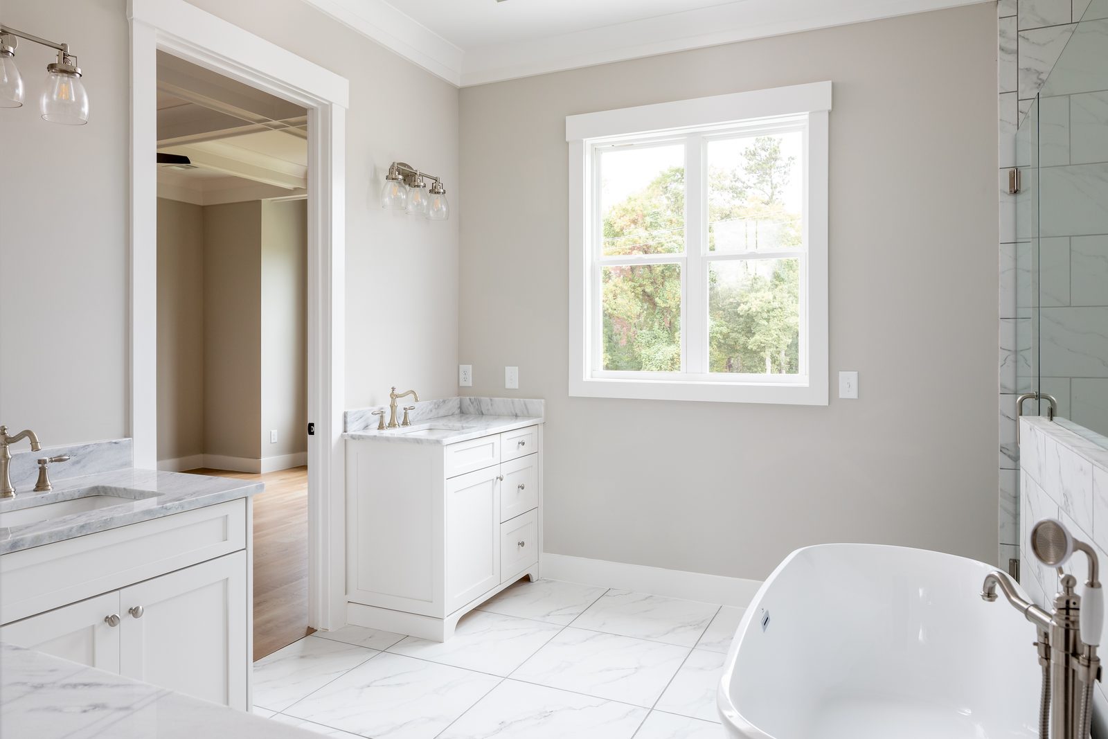 Primary bath with twin vanities and freestanding tub — Shadburn Ferry, custom home built by Ironwood Construction Group in Buford, Georgia