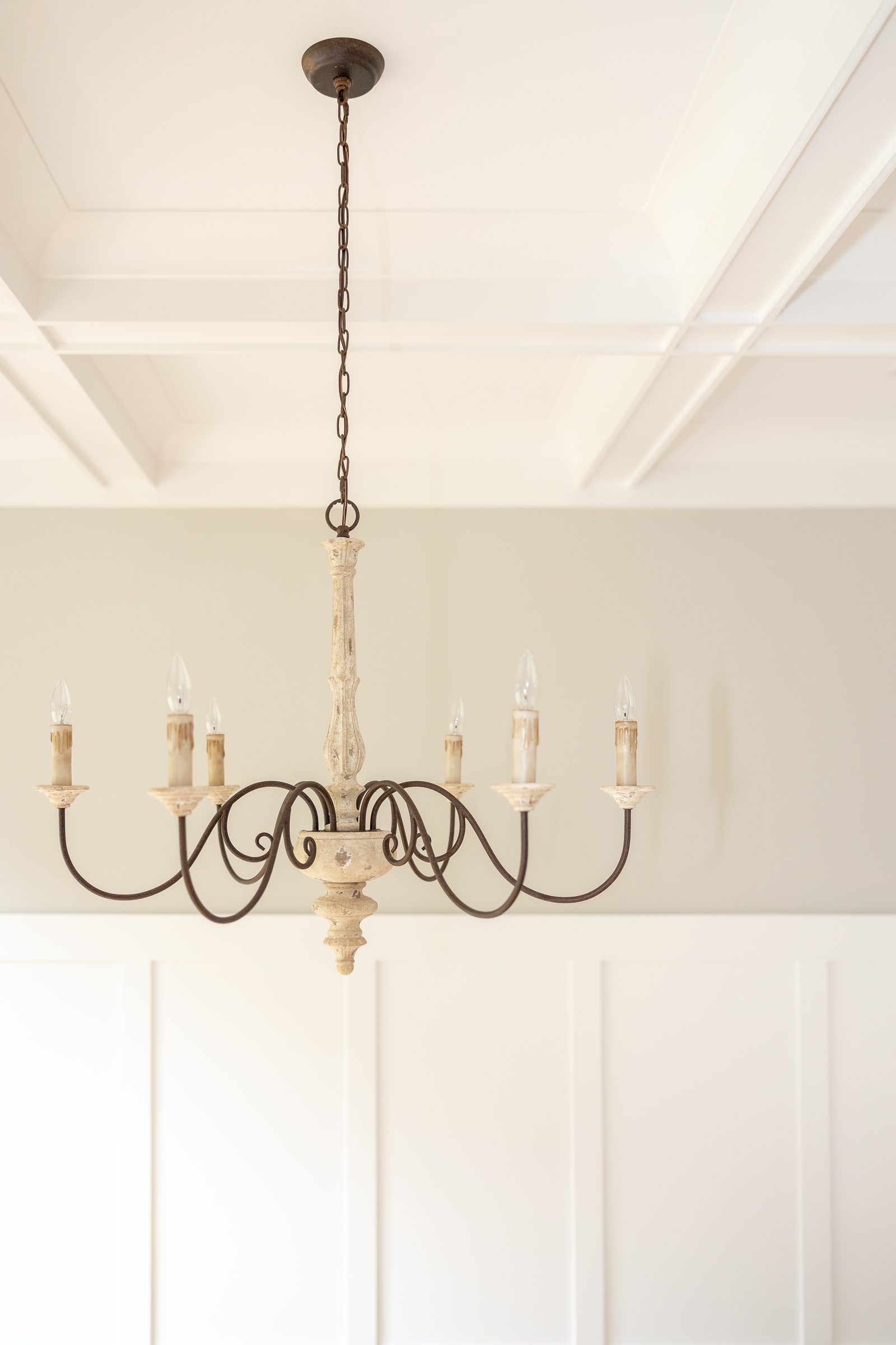 Candle chandelier above board-and-batten wainscoting — Shadburn Ferry, custom home built by Ironwood Construction Group in Buford, Georgia