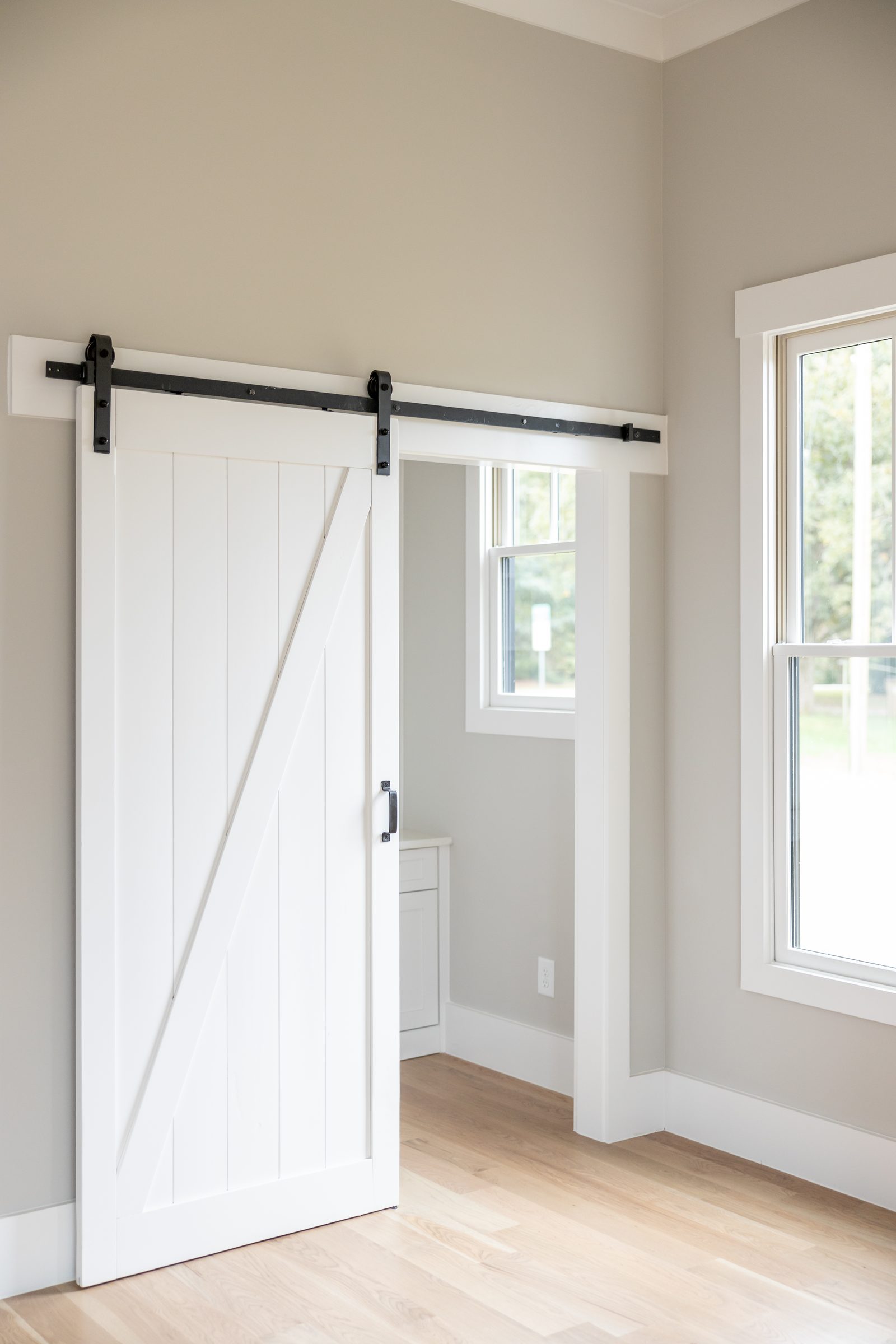 Sliding barn door at the pantry entrance — Shadburn Ferry, custom home built by Ironwood Construction Group in Buford, Georgia