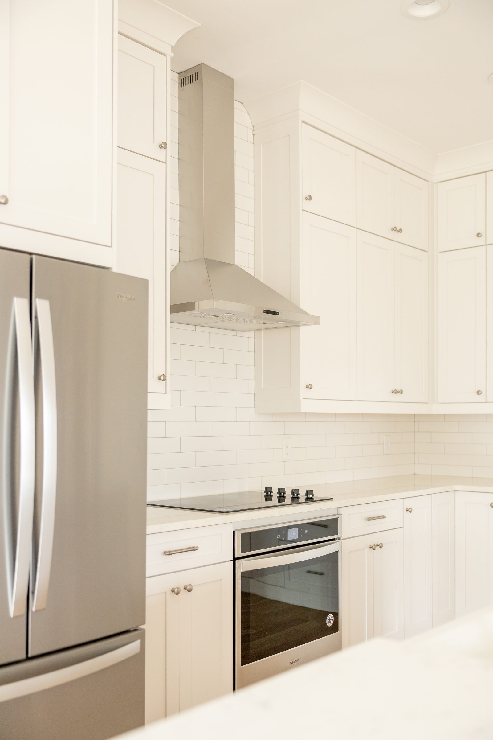 Kitchen seen from the breakfast area with stainless appliances — Shadburn Ferry, custom home built by Ironwood Construction Group in Buford, Georgia