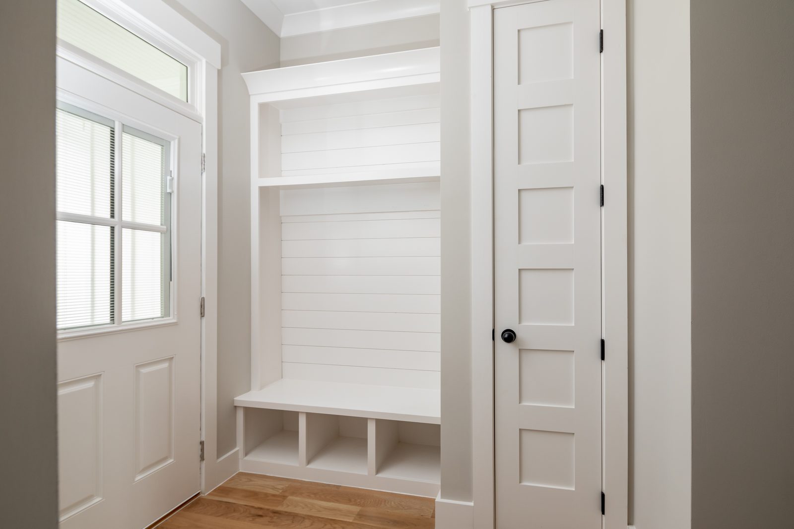 Mudroom bench and lockers at the side entry — Shadburn Ferry, custom home built by Ironwood Construction Group in Buford, Georgia