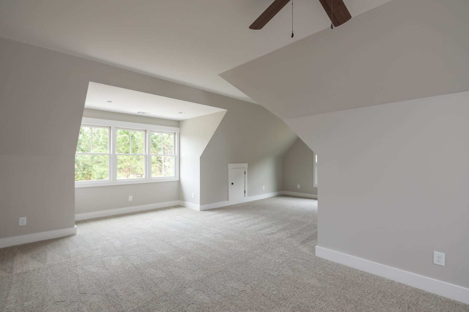 Upstairs bonus room with dormer window and carpet — Shadburn Ferry, custom home built by Ironwood Construction Group in Buford, Georgia