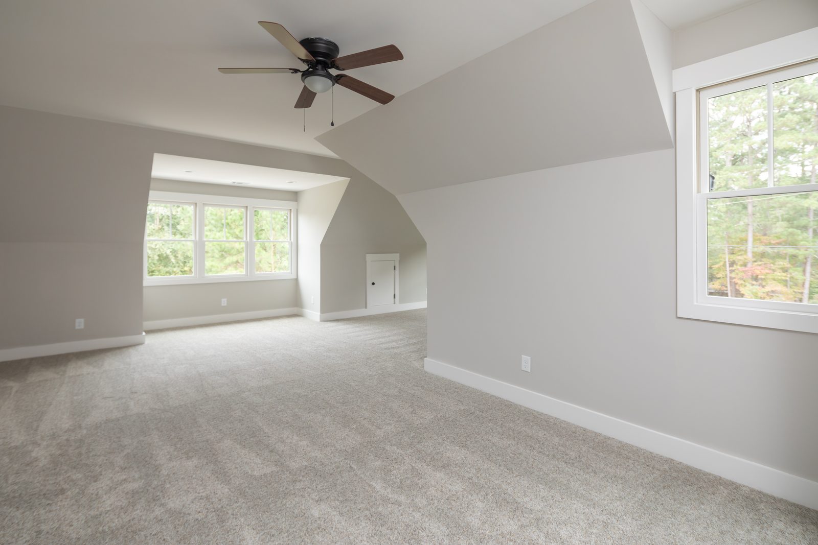Bonus room with dormer windows and ceiling fan — Shadburn Ferry, custom home built by Ironwood Construction Group in Buford, Georgia